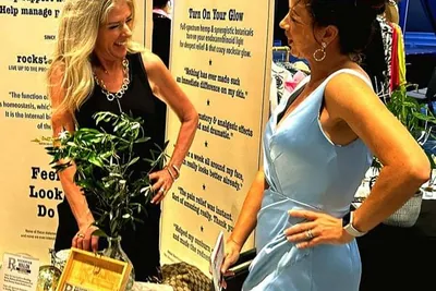 Sarasota Crew moms together, just at a fashion show instead of a regatta.