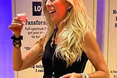 Heather toasts friends from last year at the Rockstar Blends booth | Cannadelic 2024