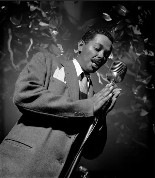 A person singing into a vintage ribbon microphone